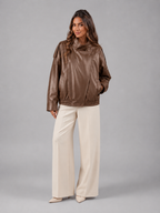 Faux leather bomber jacket – fabric texture close-up – Nude & Nero